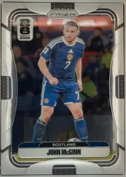 Front of 2026 Panini Prizm FIFA Soccer Cards John McGinn #395 Prizm, portrait soccer card front. A full-body image of John McGinn in a blue Scotland kit occupies the center against a blurred stadium background. The…