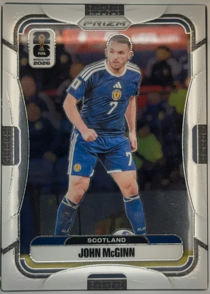 Front of 2026 Panini Prizm FIFA Soccer Cards John McGinn #395 Prizm, portrait soccer card front. A full-body image of John McGinn in a blue Scotland kit occupies the center against a blurred stadium background. The…