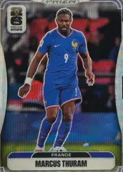 Front of 2026 Panini Prizm FIFA Soccer Cards Marcus Thuram #26, front-facing portrait soccer card. A full-body image of Marcus Thuram in a blue France kit occupies the center, with a stadium background. The FIFA…