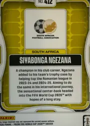 Back of 2026 Panini Prizm FIFA Soccer Cards Siyabonga Ngezana #412, upright portrait-format card back. A gold and olive patterned field is framed by layered white and black borders. Card number “No. 412” appears at…