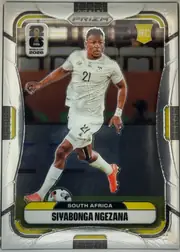 Front of 2026 Panini Prizm FIFA Soccer Cards Siyabonga Ngezana #412, portrait-oriented soccer card front. A player in a white South Africa kit is shown running with the ball against a stadium background. The top has…