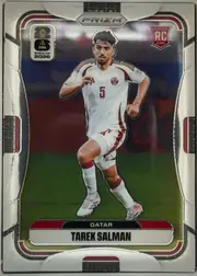 Front of 2026 Panini Prizm FIFA Soccer Cards TAREK SALMAN #374, portrait soccer card front. A Qatar player wearing a white and maroon kit is pictured running on a soccer field. The top center carries PANINI and…
