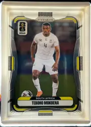 Front of 2026 Panini Prizm FIFA Soccer Cards Teboho Mokoena #414, portrait-oriented front with a central full-body soccer player image in a white South Africa uniform, dark stadium background, yellow and…