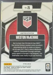 Back of 2026 Panini Prizm FIFA Trophy Hunting Weston McKennie #21, upright portrait-format card back. A black-and-white geometric soccer design surrounds a red circular center. At the top is a white plaque reading…