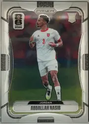 Front of 2026 Panini Prizm FIFA World Cup Soccer Abdallah Nasib #271, portrait soccer card front. A player in a white Jordan uniform with red trim and number 3 is shown running on a soccer field. The FIFA World Cup…