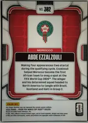 Back of 2026 Panini Prizm FIFA World Cup Soccer ABDE EZZALZOULI #302, upright portrait-oriented card back. A white and black geometric outer frame surrounds a red patterned central panel. Near the top is a white…