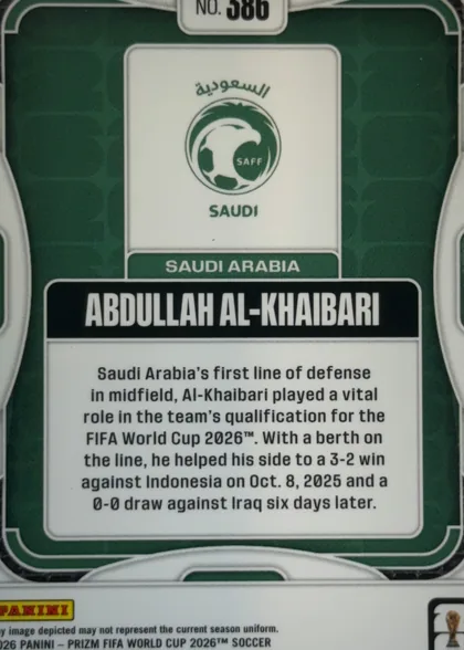 Back of 2026 Panini Prizm FIFA World Cup Soccer ABDULLAH AL-KHAIBARI #586, upright portrait-oriented card back. A dark green field is enclosed by a white rounded border and decorative white curved corner elements. At the…
