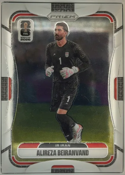 Front of 2026 Panini Prizm FIFA World Cup Soccer Alireza Beiranvand #244, front of a soccer card. Top center has a silver hexagonal badge reading 'PRIZM'. Upper left carries a white rounded logo with the FIFA World Cup…