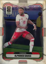 Front of 2026 Panini Prizm FIFA World Cup Soccer Alphonso Davies #165, portrait-oriented soccer card front. The upper section shows PRIZM branding and a FIFA World Cup 2026 emblem. A soccer player in a white-and-red…