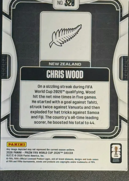 Back of 2026 Panini Prizm FIFA World Cup Soccer Chris Wood #320, back of a soccer trading card. A black-and-white geometric design frames a centered white panel containing a stylized New Zealand fern emblem, the…