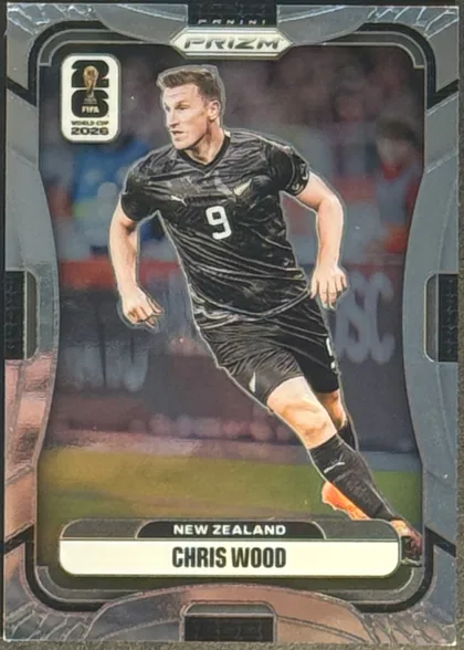 Front of 2026 Panini Prizm FIFA World Cup Soccer Chris Wood #320, portrait soccer card front. A centered action image shows Chris Wood in a black New Zealand kit with number 9. The top has PANINI branding and a…