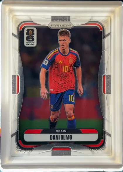 Front of 2026 Panini Prizm FIFA World Cup Soccer DANI OLMO #82 Base, front-facing portrait soccer card. The PANINI logo is centered at the top above a PRIZM plaque. A FIFA WORLD CUP 2026 emblem appears near the…