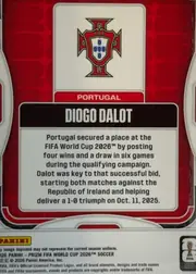Back of 2026 Panini Prizm FIFA World Cup Soccer Diogo Dalot Base, portrait-oriented card back. A Portugal crest appears in a large white rounded panel near the top, with PORTUGAL in white lettering on a red bar…