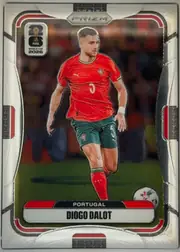 Front of 2026 Panini Prizm FIFA World Cup Soccer Diogo Dalot Base, upright portrait soccer card. A Portugal player in a red jersey and green shorts is shown running with a ball on a field. The top center has PANINI…