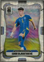 Front of 2026 Panini Prizm FIFA World Cup Soccer Esmir Bajraktarević #476 Silver Prizm, front of a soccer card. A full-body die-cut action photo of a player in a blue and yellow Bosnia-Herzegovina kit (number 5) is centered against a…