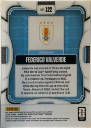Back of 2026 Panini Prizm FIFA World Cup Soccer Federico Valverde, upright card back featuring a blue geometric patterned background. A centered white rounded panel contains the Uruguay crest at the top, a blue band…