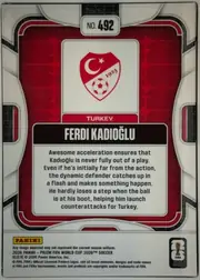 Back of 2026 Panini Prizm FIFA World Cup Soccer Ferdi Kadıoğlu #492 Base, upright portrait-oriented card back. A red patterned central field is framed by white, black, and gray geometric borders. At the top center is a…