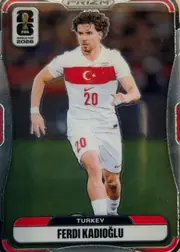 Front of 2026 Panini Prizm FIFA World Cup Soccer Ferdi Kadıoğlu #492 Base, portrait soccer card showing Ferdi Kadıoğlu running in a white Turkey uniform with red chest band and number 20. A FIFA World Cup 2026 emblem is at…