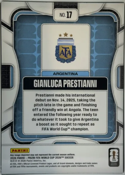 Back of 2026 Panini Prizm FIFA World Cup Soccer Gianluca Prestianni #17 Base, upright portrait-oriented card back. A blue patterned central field is surrounded by a white and gray geometric border. At the top center is a…
