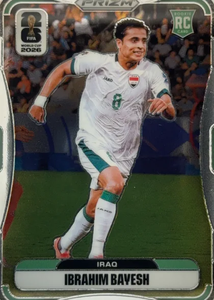 Front of 2026 Panini Prizm FIFA World Cup Soccer Ibrahim Bayesh #453, front of a Prizm soccer card. A full-bleed stadium photo (crowd and green pitch) forms the background. Overlaid is a contour/die-cut action photo of…