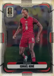 Front of 2026 Panini Prizm FIFA World Cup Soccer Ismael Koné #169 Base, upright portrait soccer card front. A player in a red Canada uniform is shown in action against a blurred stadium background. The FIFA World Cup…