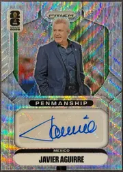 Front of 2026 Panini Prizm FIFA World Cup Soccer Javier Aguirre #P-JA Penmanship autograph autographed, upright portrait-format soccer trading card. A multicolor holographic/prismatic foil pattern covers the background. The Panini PRIZM logo is…