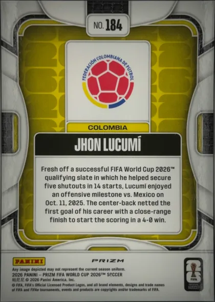 Back of 2026 Panini Prizm FIFA World Cup Soccer Jhon Lucumí, back of a soccer player card. A Colombia federation crest appears at the top inside a white panel, with COLOMBIA on a yellow strip beneath it. A…