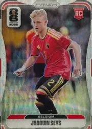 Front of 2026 Panini Prizm FIFA World Cup Soccer Joaquin Seys #158 Prizm (refractor), front of a Prizm soccer card. A die-cut-style action photo of a young male player with short blond hair, wearing a red Belgium national-team jersey…