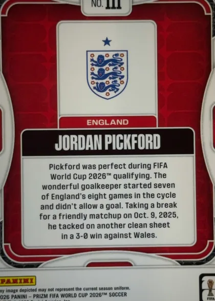 Back of 2026 Panini Prizm FIFA World Cup Soccer Jordan Pickford #111, upright portrait-format card back. A red patterned background is framed by white and gray rounded borders. Near the top center is a white panel…