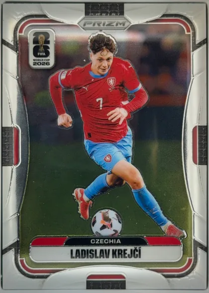 Front of 2026 Panini Prizm FIFA World Cup Soccer Ladislav Krejčí #483 Die-Cut Prizm, front of a die-cut soccer card. A full-body action photo of a player in a red long-sleeve jersey (number 7, Czechia lion crest, Puma logo)…