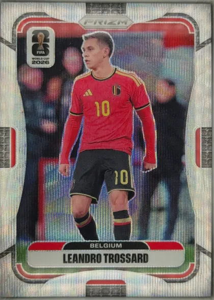 Front of 2026 Panini Prizm FIFA World Cup Soccer Leandro Trossard #159, portrait soccer card front. A full-body image of Leandro Trossard in a red Belgium uniform occupies the center. The FIFA World Cup 2026 logo is at…