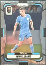 Front of 2026 Panini Prizm FIFA World Cup Soccer Manuel Ugarte #124 Base, portrait soccer card front. A full-body photograph of Manuel Ugarte in a light blue Uruguay kit occupies the central image area. The top center has…