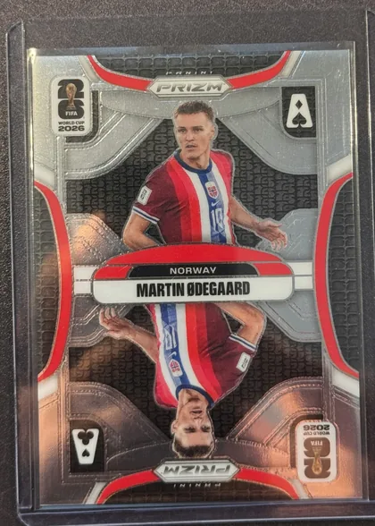 Front of 2026 Panini Prizm FIFA World Cup Soccer MARTIN ØDEGAARD #20, portrait soccer card front featuring Martin Ødegaard in a Norway kit. The player image occupies the center, with a metallic silver and gray…