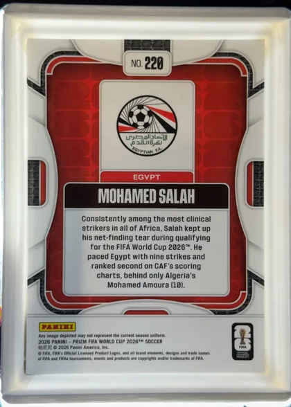 Back of 2026 Panini Prizm FIFA World Cup Soccer MOHAMED SALAH #220 Base, upright portrait-oriented card back. A white and gray futuristic frame surrounds a red patterned central panel with black textured accents. At the…