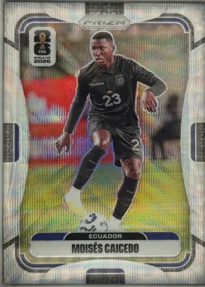 Front of 2026 Panini Prizm FIFA World Cup Soccer Moisés Caicedo #210 Prizm, upright portrait-format soccer card front. A player in a black Ecuador kit, number 23, is shown dribbling a ball against a stadium background. The…