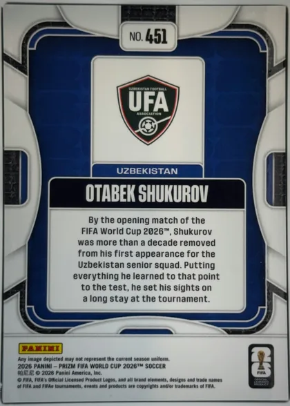Back of 2026 Panini Prizm FIFA World Cup Soccer OTABEK SHUKUROV #451, back of a portrait-oriented soccer card. A centered top label reads "NO. 451". The upper central panel displays the Uzbekistan Football Association…
