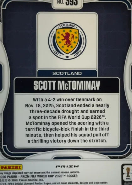Back of 2026 Panini Prizm FIFA World Cup Soccer Scott McTominay #595 Prizm, upright portrait-format card back. A dark navy field is framed by white rounded border lines. Near the top is a white number tab reading "NO. 595"…