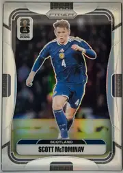 Front of 2026 Panini Prizm FIFA World Cup Soccer Scott McTominay #595 Prizm, portrait soccer card front. A full-body action photograph of Scott McTominay in a blue Scotland kit occupies the center against a dark stadium…
