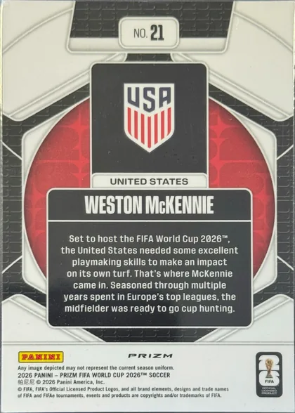 Back of 2026 Panini Prizm FIFA World Cup Soccer Weston McKennie #21, upright portrait-format card back. A black-and-white geometric soccer design surrounds a red circular center. At the top is a white plaque reading…