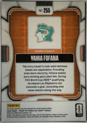 Back of 2026 Panini Prizm FIFA World Cup Soccer Yahia Fofana #255 Base, upright portrait-format card back. A white capsule at the top contains “NO. 255”. The center has an orange patterned panel with a white inset…