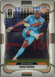 Front of 2026 Panini Prizm FIFA World Cup Soccer Yahia Fofana #255 Base, portrait-oriented soccer card front. A goalkeeper in a light blue Ivory Coast kit is pictured diving in front of a goal net. The PRIZM logo is…