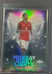 Front of 2026 Topps Chrome Premier League Leny Yoro #MNL-29 Base Insert, portrait soccer card front showing Leny Yoro in a red Manchester United kit against a dark stadium-like background with bright circular light…
