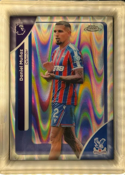 Front of 2026 Topps Chrome Premier League Soccer Cards Daniel Muñoz #80 Base, front of a soccer card shown rotated 90 degrees. A player in a red-and-blue striped Crystal Palace home kit with '388' sponsor and number 2 on the…