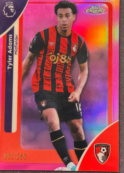Front of 2026 Topps Chrome Premier League Soccer Cards Tyler Adams #2 Numbered parallel /250, serial numbered 002/250, upright portrait soccer card showing Tyler Adams in an AFC Bournemouth red-and-black kit. His name is printed vertically on a dark blue panel along…