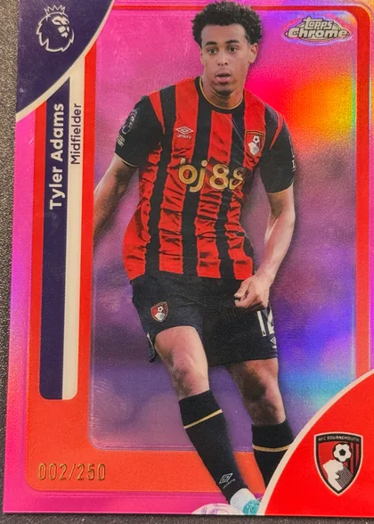 Front of 2026 Topps Chrome Premier League Soccer Cards Tyler Adams #2 Pink parallel /250, serial numbered 002/250, portrait soccer card featuring Tyler Adams in an AFC Bournemouth red-and-black striped kit. His name appears vertically in a dark navy panel along…